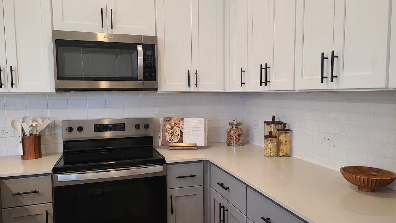 Stainless steel appliances and two toned cabinetry inside homes at the parcHAUS at Mustang Drive